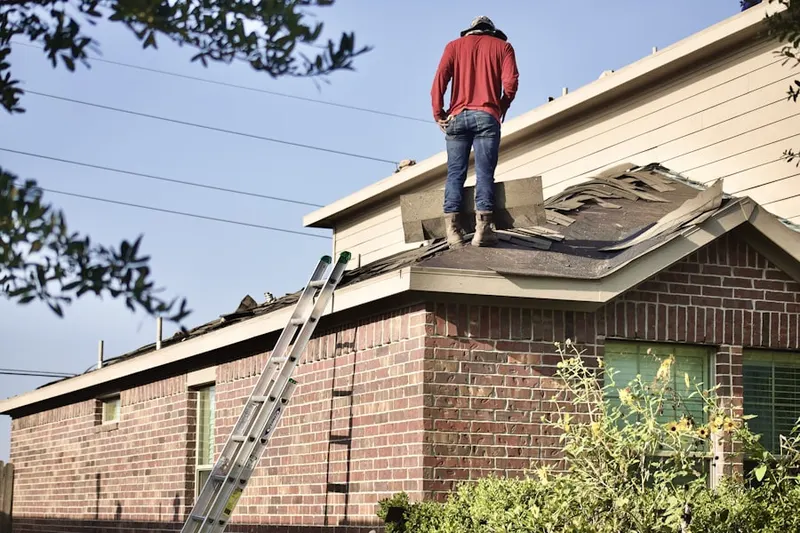 Professional roofer working on a residential roof in Robinwood
